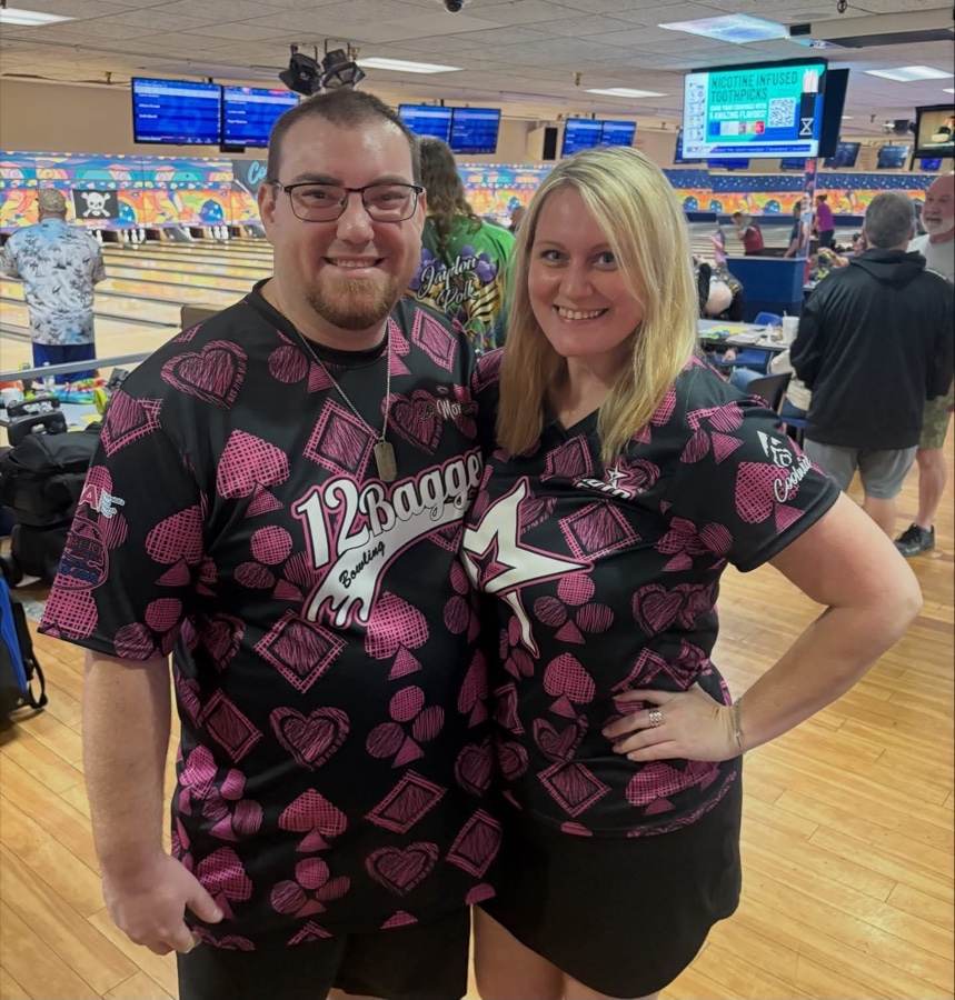 A couple in matching pink card-suit 12Bagger jerseys