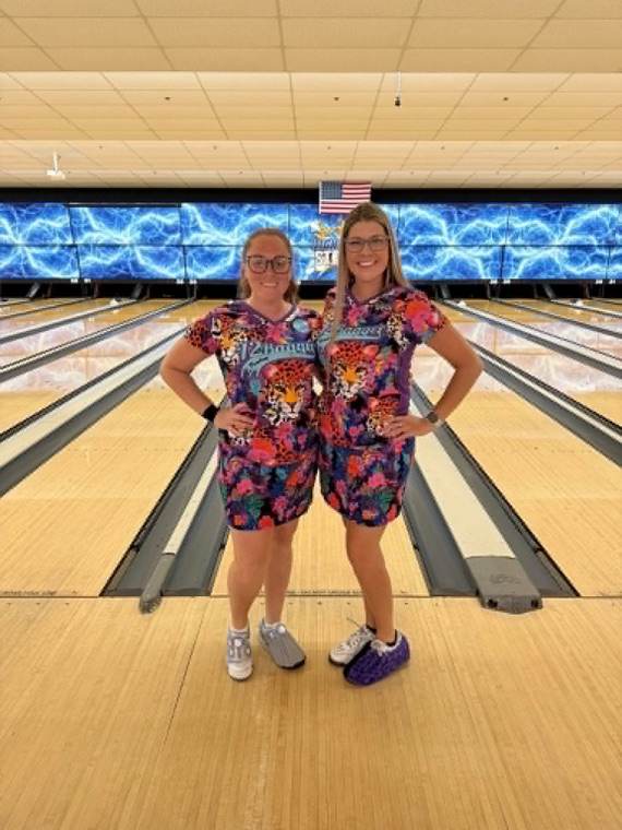 Two bowlers in leopard and floral 12Bagger jerseys in front of the lanes