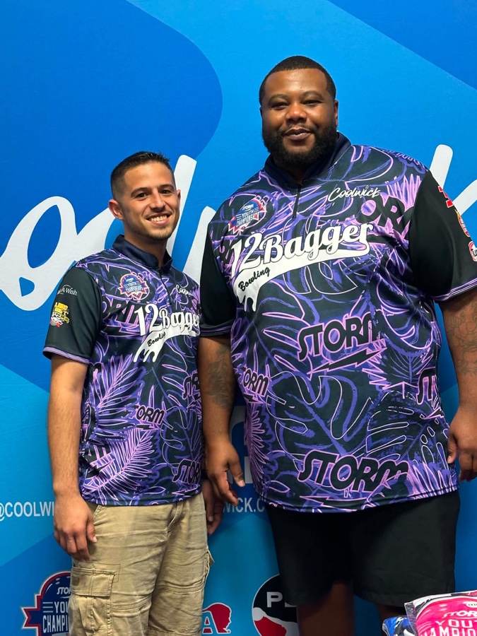 Two bowlers in matching purple 12Bagger and Storm jerseys