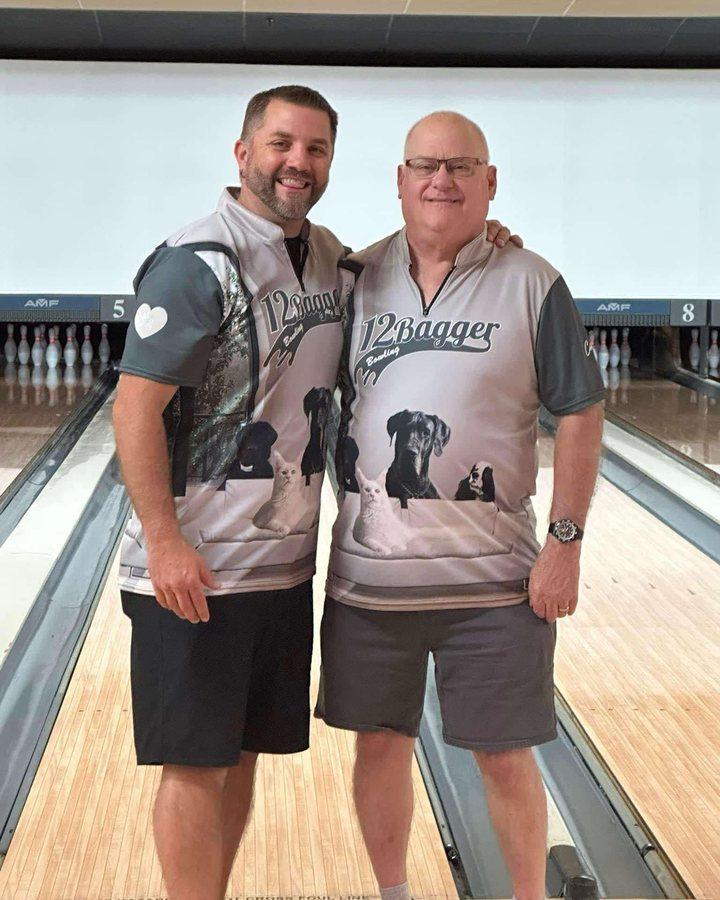 Two bowlers in matching photo-print 12Bagger jerseys standing on the approach