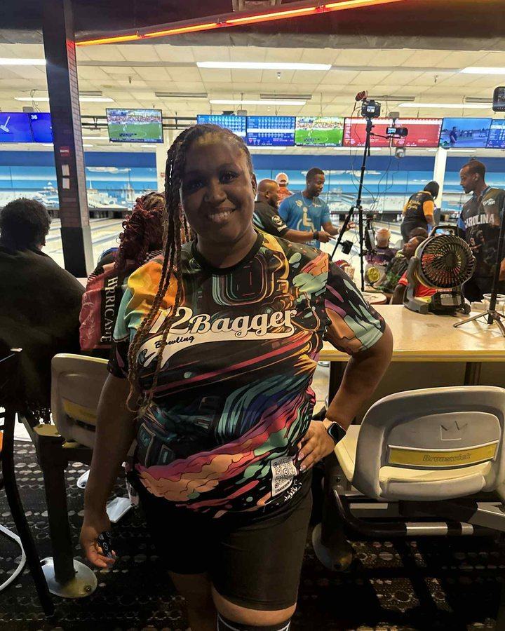 A bowler in a bright abstract-print 12Bagger jersey on a tournament floor